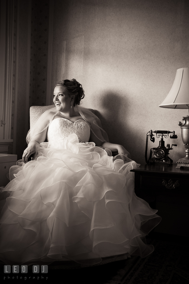 Beautiful bride sitting by the window, laughing. Kent Manor Inn, Kent Island, Eastern Shore Maryland, wedding ceremony and getting ready photos, by wedding photographers of Leo Dj Photography. http://leodjphoto.com