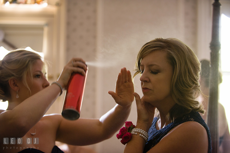 Bride's sister spraying hair spray on Mother's hair. Kent Manor Inn, Kent Island, Eastern Shore Maryland, wedding ceremony and getting ready photos, by wedding photographers of Leo Dj Photography. http://leodjphoto.com