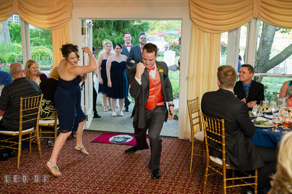 Groomsman and bridesmaid showing of fists and guns during introduction entrance. Kent Manor Inn, Kent Island, Eastern Shore Maryland, wedding reception and ceremony photo, by wedding photographers of Leo Dj Photography. http://leodjphoto.com