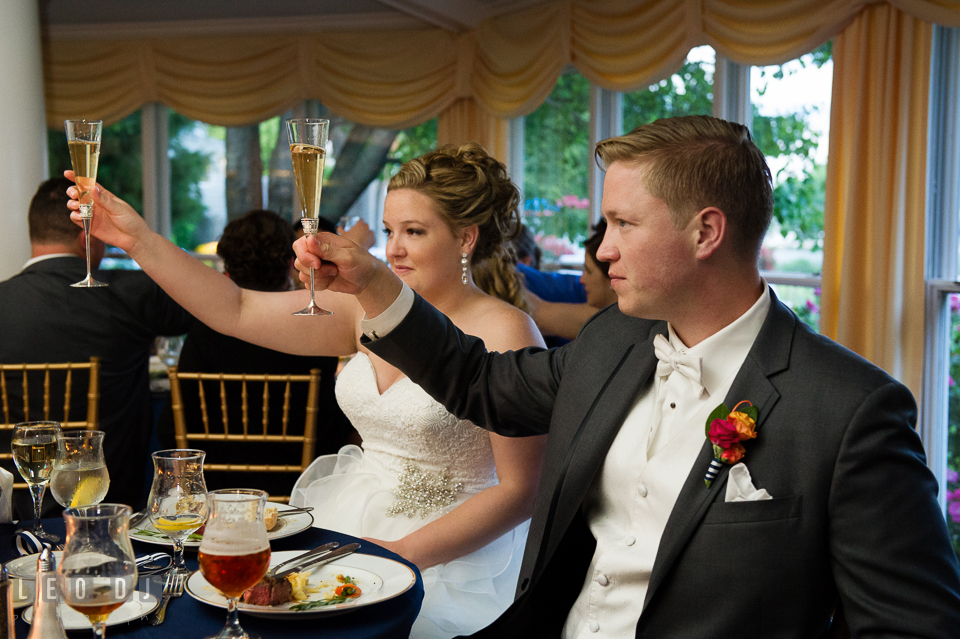 Bride and Groom raised their champagne glasses during the toast. Kent Manor Inn, Kent Island, Eastern Shore Maryland, wedding reception and ceremony photo, by wedding photographers of Leo Dj Photography. http://leodjphoto.com