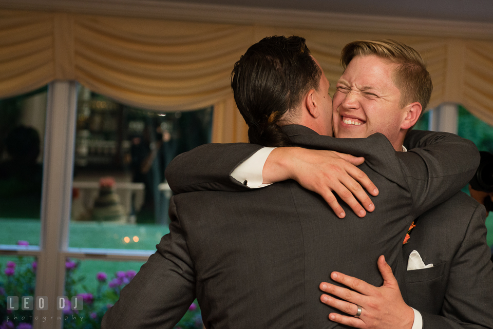 Groom hugging Best Man after his toast speech. Kent Manor Inn, Kent Island, Eastern Shore Maryland, wedding reception and ceremony photo, by wedding photographers of Leo Dj Photography. http://leodjphoto.com