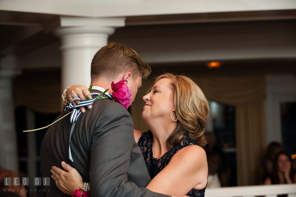 The Mother of the Groom holding a single red rose during the parent dance. Kent Manor Inn, Kent Island, Eastern Shore Maryland, wedding reception and ceremony photo, by wedding photographers of Leo Dj Photography. http://leodjphoto.com