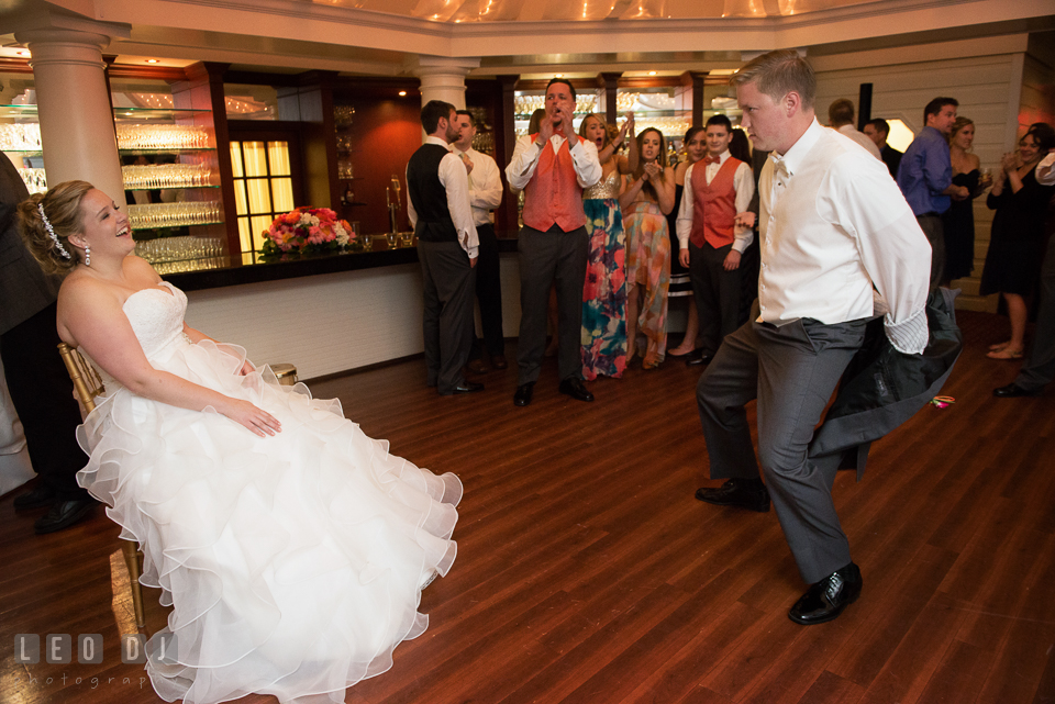 Groom took off his jacket preparing to get garter from Bride. Kent Manor Inn, Kent Island, Eastern Shore Maryland, wedding reception and ceremony photo, by wedding photographers of Leo Dj Photography. http://leodjphoto.com