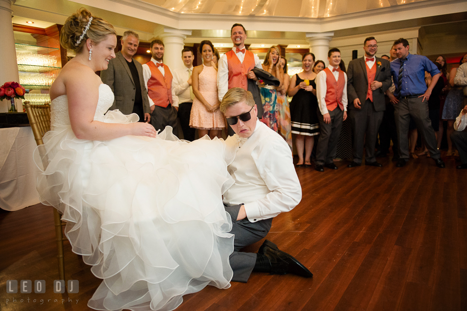 Groom searching for garter under Bride's wedding gown. Kent Manor Inn, Kent Island, Eastern Shore Maryland, wedding reception and ceremony photo, by wedding photographers of Leo Dj Photography. http://leodjphoto.com