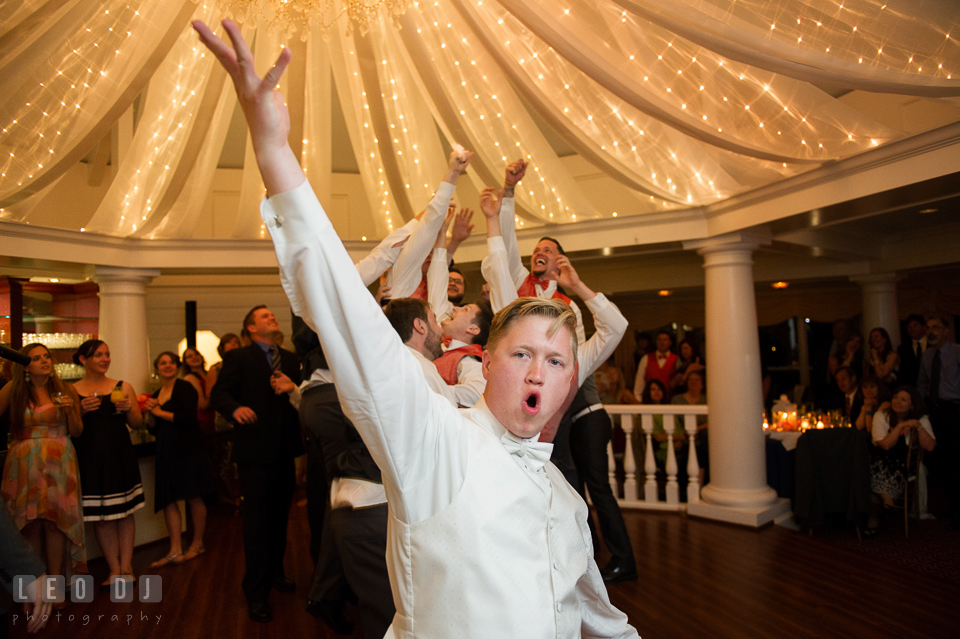 Groom tossed garter and caught by one of the groomsmen. Kent Manor Inn, Kent Island, Eastern Shore Maryland, wedding reception and ceremony photo, by wedding photographers of Leo Dj Photography. http://leodjphoto.com