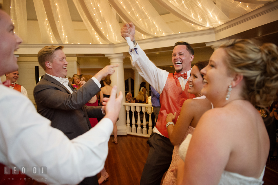 Best Man cheered after Groomsmen gave garter to him. Kent Manor Inn, Kent Island, Eastern Shore Maryland, wedding reception and ceremony photo, by wedding photographers of Leo Dj Photography. http://leodjphoto.com