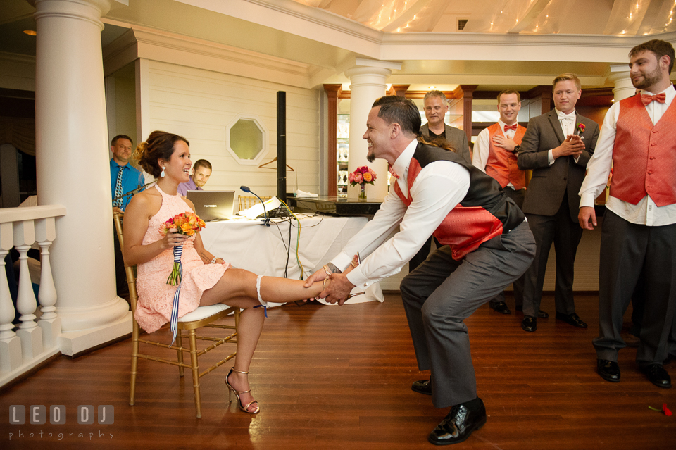 Best Man putting garter on his fianceé. Kent Manor Inn, Kent Island, Eastern Shore Maryland, wedding reception and ceremony photo, by wedding photographers of Leo Dj Photography. http://leodjphoto.com