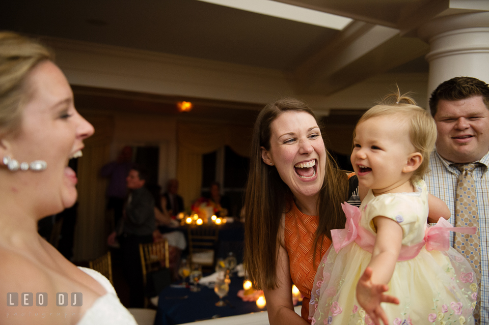 Baby, her mother, and Bride laughing after baby blew kiss. Kent Manor Inn, Kent Island, Eastern Shore Maryland, wedding reception and ceremony photo, by wedding photographers of Leo Dj Photography. http://leodjphoto.com