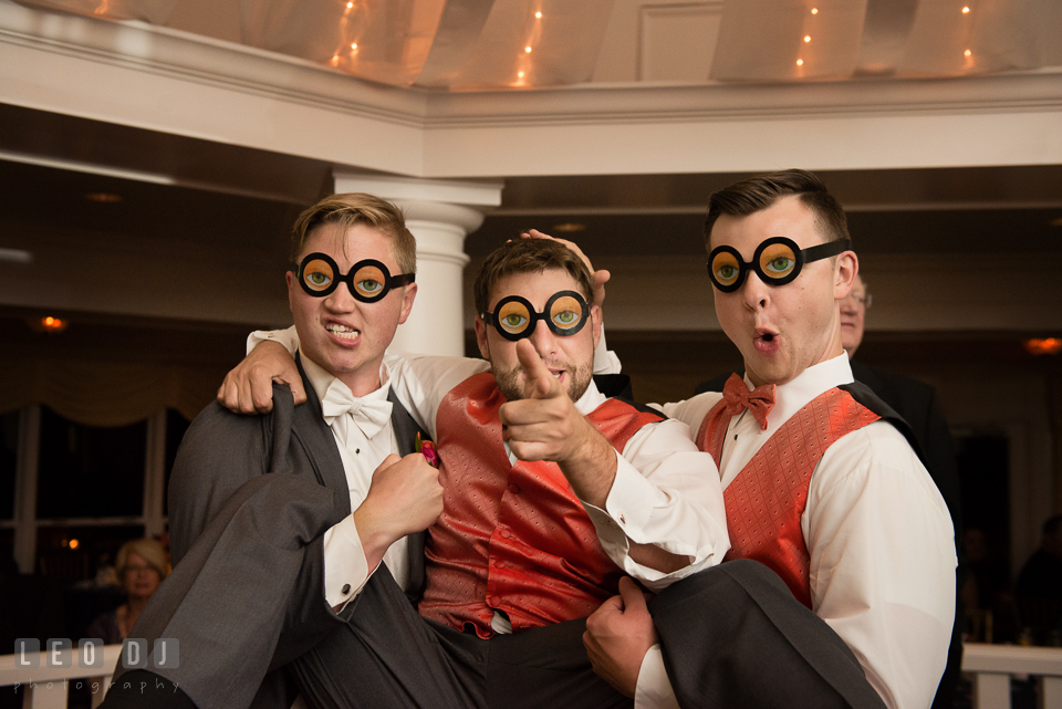 Groom and groomsmen posing silly with silly eye glasses. Kent Manor Inn, Kent Island, Eastern Shore Maryland, wedding reception and ceremony photo, by wedding photographers of Leo Dj Photography. http://leodjphoto.com