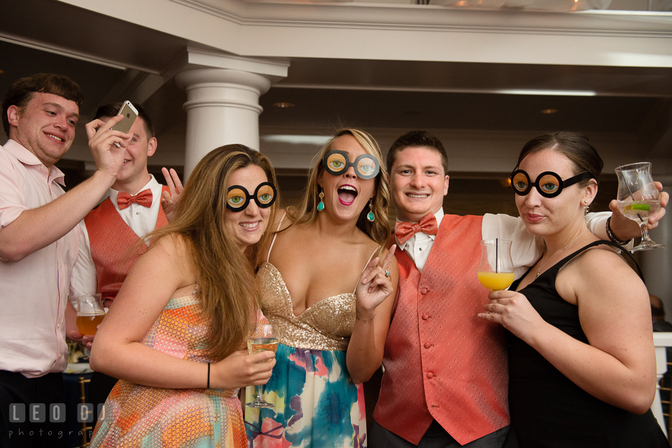 Guests having fun posing with silly glasses. Kent Manor Inn, Kent Island, Eastern Shore Maryland, wedding reception and ceremony photo, by wedding photographers of Leo Dj Photography. http://leodjphoto.com