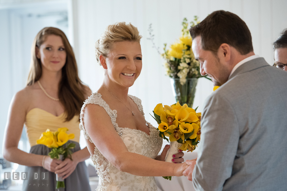 Bride smiling wide while listening to Groom reciting his vows. Maryland Yacht Club wedding at Pasadena Maryland, by wedding photographers of Leo Dj Photography. http://leodjphoto.com