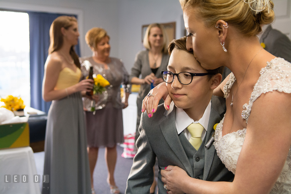 Bride hugging and kissing her son. Maryland Yacht Club wedding at Pasadena Maryland, by wedding photographers of Leo Dj Photography. http://leodjphoto.com