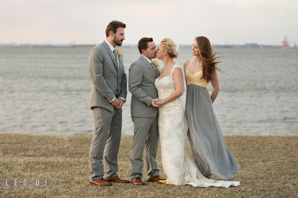 Best Man and Maid of Honor watching the Bride and Groom kissing during the wedding party outdoor photo session. Maryland Yacht Club wedding at Pasadena Maryland, by wedding photographers of Leo Dj Photography. http://leodjphoto.com