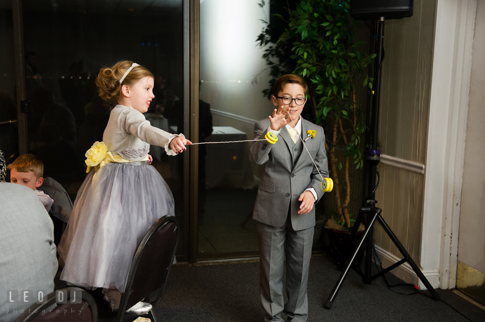 Ring bearer boy and flower girl playing yo-yo. Maryland Yacht Club wedding at Pasadena Maryland, by wedding photographers of Leo Dj Photography. http://leodjphoto.com