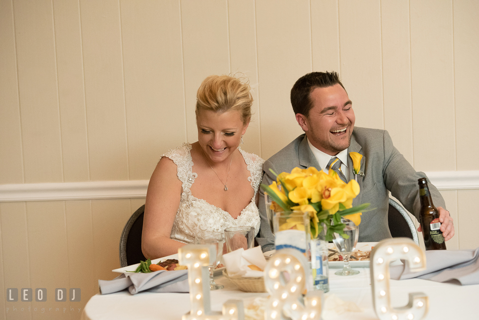 Bride and Groom laughing listening to toast speech from the Maid of Honor and Best Man. Maryland Yacht Club wedding at Pasadena Maryland, by wedding photographers of Leo Dj Photography. http://leodjphoto.com