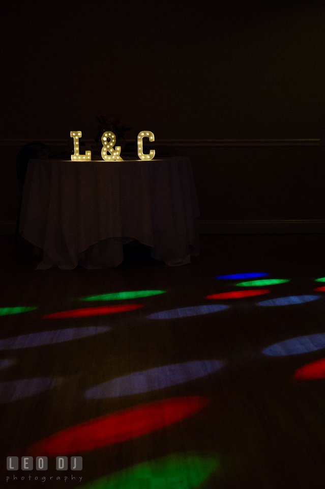 Initial of the Bride and Groom's names on the sweetheart table with colorful lights from the DJ. Maryland Yacht Club wedding at Pasadena Maryland, by wedding photographers of Leo Dj Photography. http://leodjphoto.com