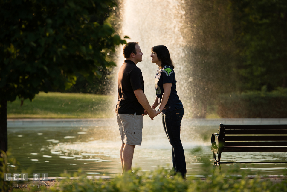 Engaged couple almost kissing by the water fountain. Quiet Waters Park Annapolis Maryland pre-wedding engagement photo session, by wedding photographers of Leo Dj Photography. http://leodjphoto.com