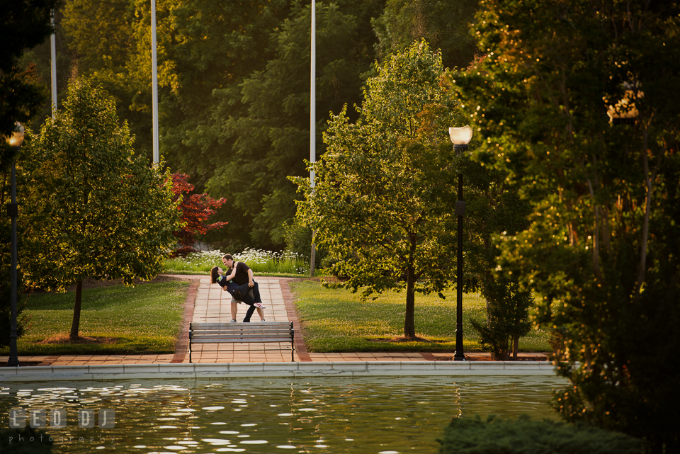 Engaged man dip kiss with his fiancée by the pool. Quiet Waters Park Annapolis Maryland pre-wedding engagement photo session, by wedding photographers of Leo Dj Photography. http://leodjphoto.com