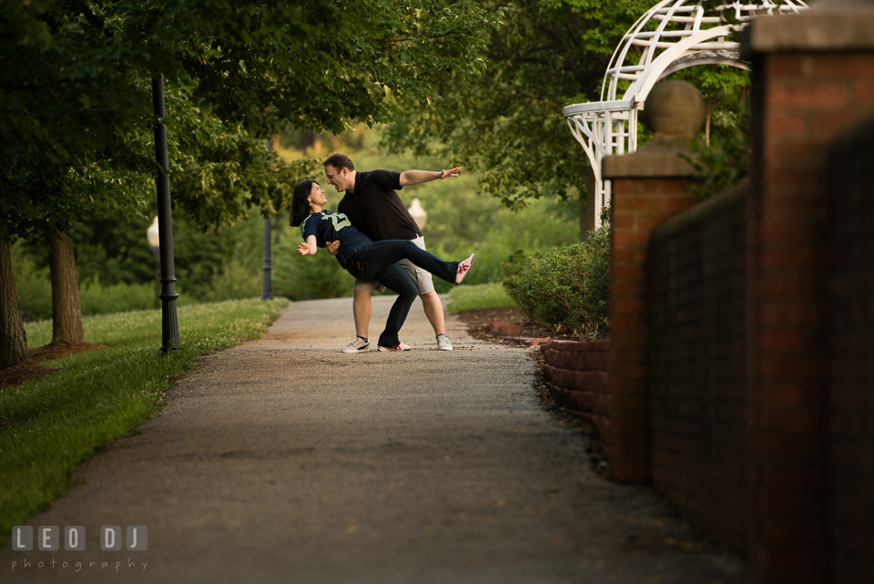 Engaged man dipping his fiancee. Quiet Waters Park Annapolis Maryland pre-wedding engagement photo session, by wedding photographers of Leo Dj Photography. http://leodjphoto.com