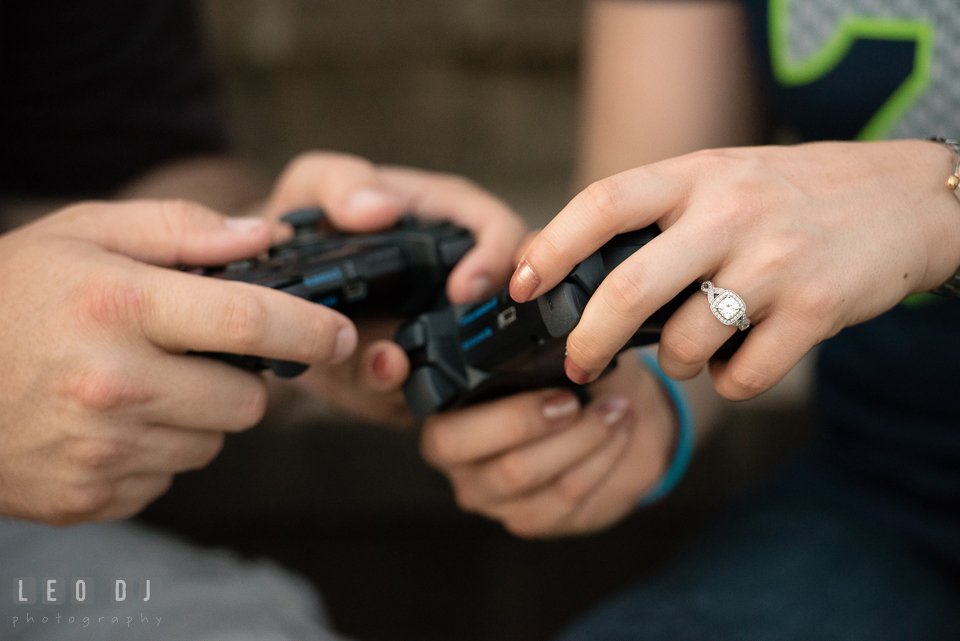 Engaged girl with her fiance holding video game controller, showing her beautiful diamond engagement ring. Quiet Waters Park Annapolis Maryland pre-wedding engagement photo session, by wedding photographers of Leo Dj Photography. http://leodjphoto.com