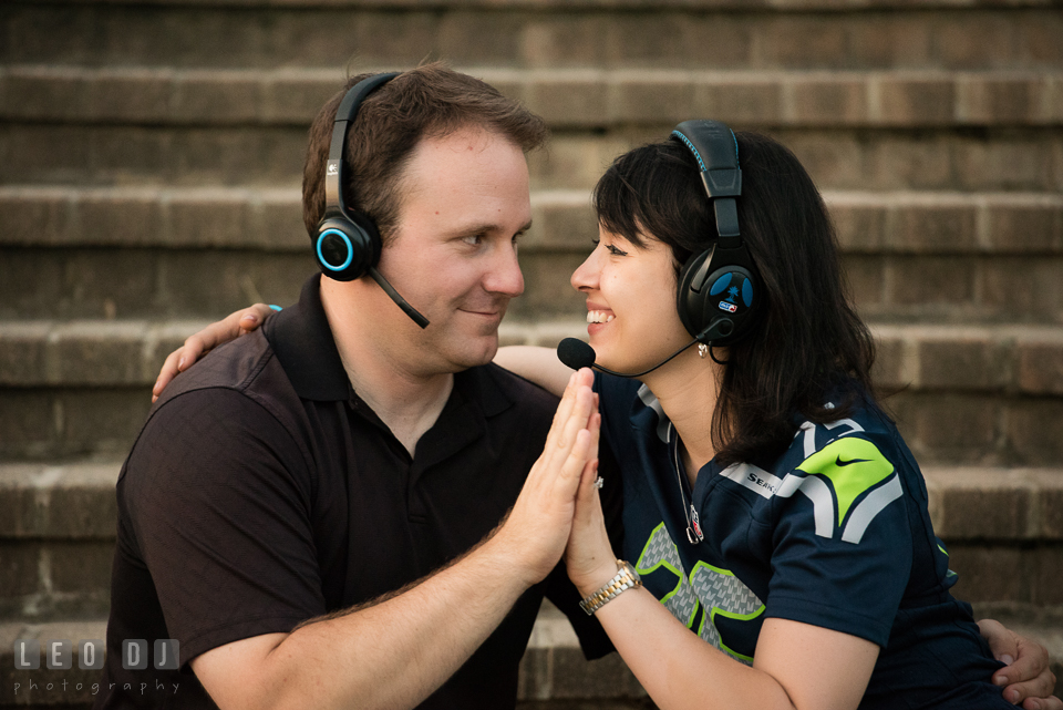 Engaged couple wearing gaming headset cuddling. Quiet Waters Park Annapolis Maryland pre-wedding engagement photo session, by wedding photographers of Leo Dj Photography. http://leodjphoto.com