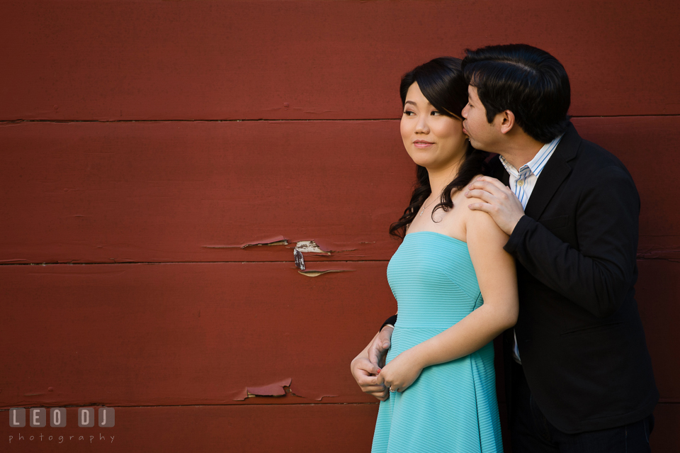 Engaged man embracing and kissing his fiancée. Annapolis Eastern Shore Maryland pre-wedding engagement photo session at downtown, by wedding photographers of Leo Dj Photography. http://leodjphoto.com