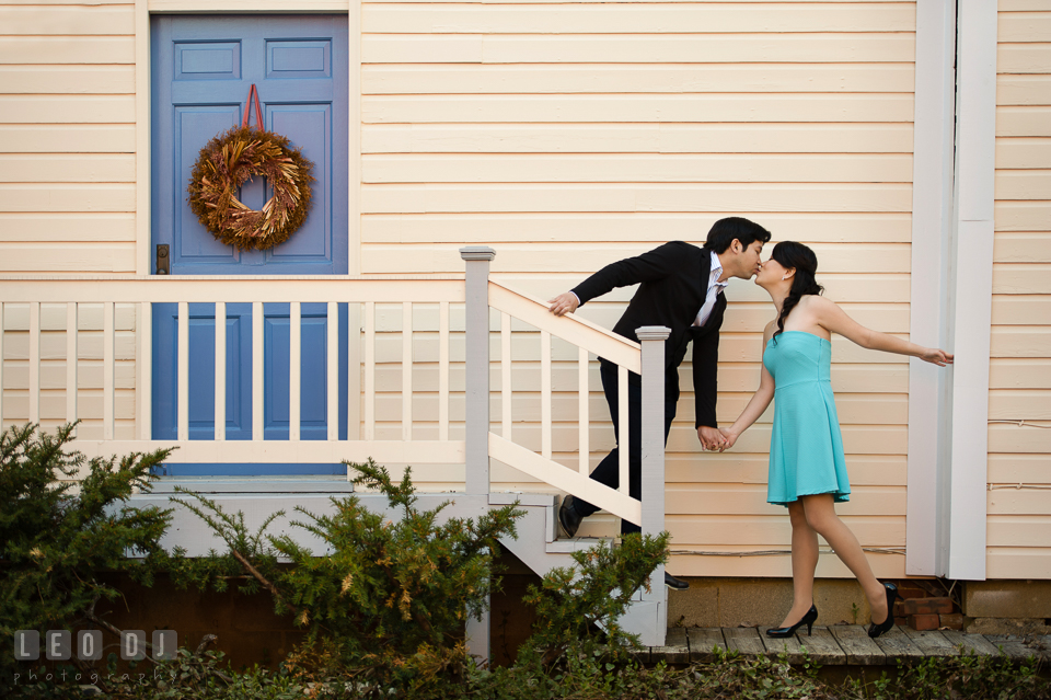 Engaged girl and her fiancé kissing by the stairs. Annapolis Eastern Shore Maryland pre-wedding engagement photo session at downtown, by wedding photographers of Leo Dj Photography. http://leodjphoto.com