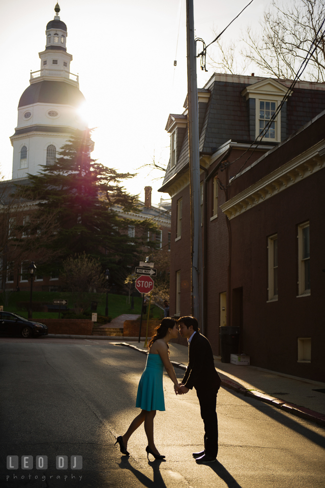 Silhouette shot of engaged couple holding hands by the Maryland State House. Annapolis Eastern Shore Maryland pre-wedding engagement photo session at downtown, by wedding photographers of Leo Dj Photography. http://leodjphoto.com