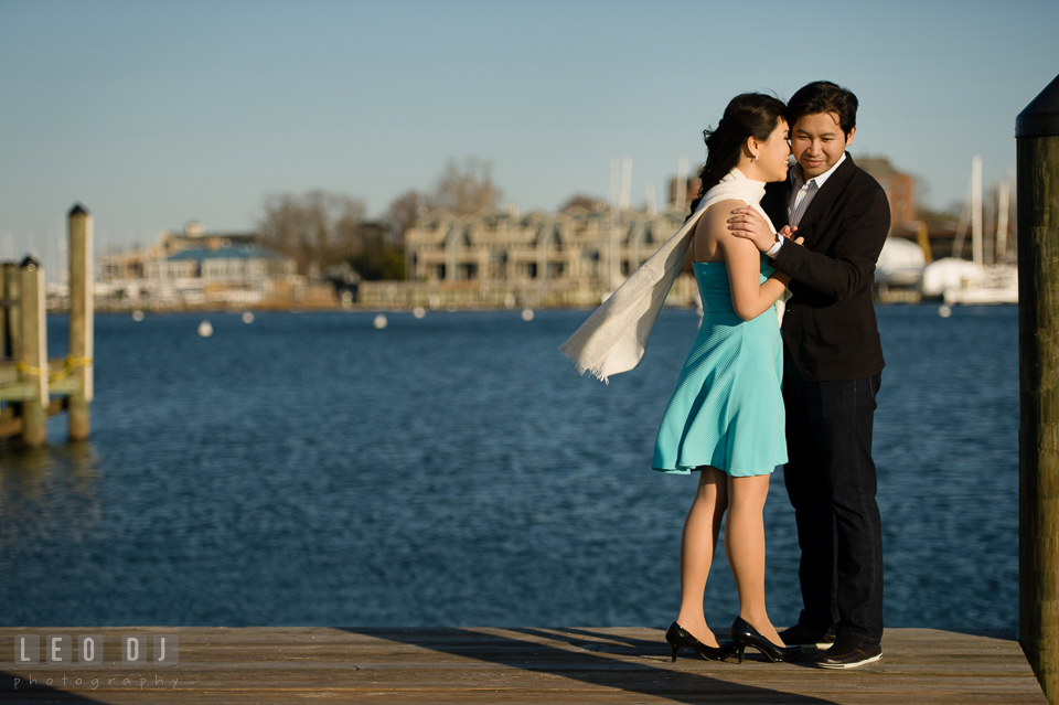 Engaged couple holding each other on the dock. Annapolis Eastern Shore Maryland pre-wedding engagement photo session at downtown, by wedding photographers of Leo Dj Photography. http://leodjphoto.com