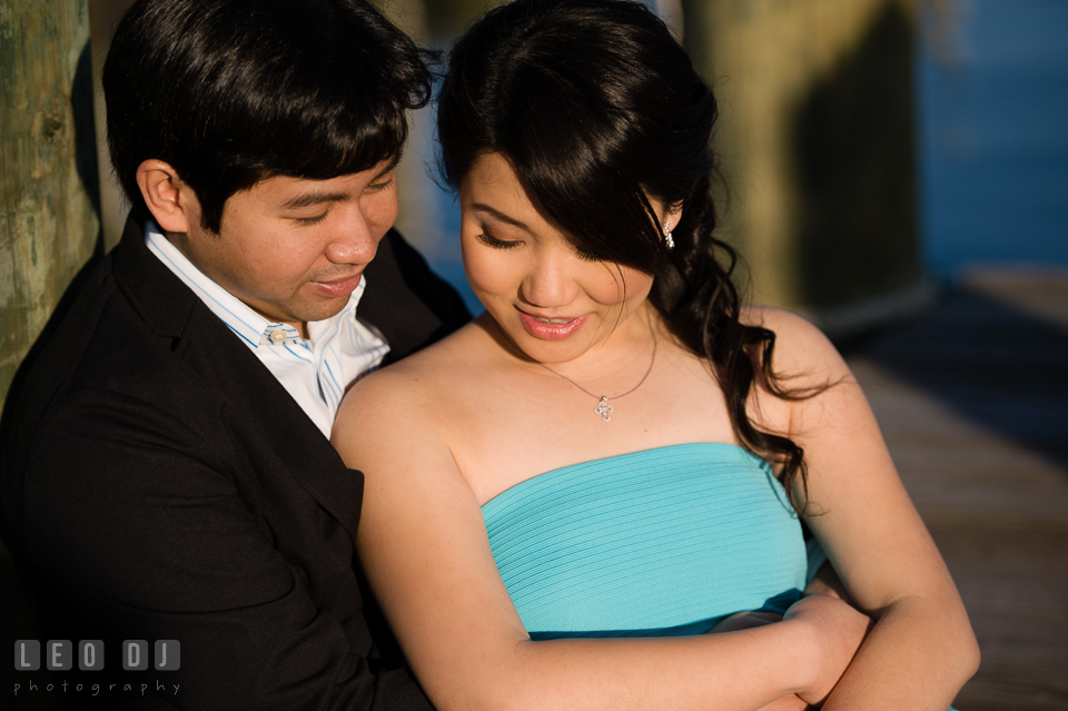 Engaged man snuggling with his fiance on the pier. Annapolis Eastern Shore Maryland pre-wedding engagement photo session at downtown, by wedding photographers of Leo Dj Photography. http://leodjphoto.com