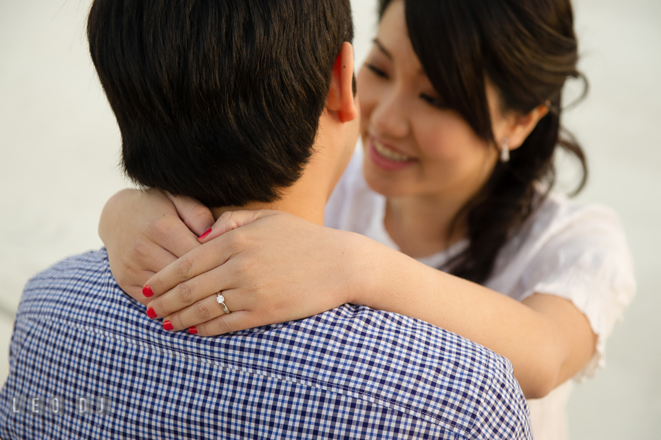 Engaged girl embracing her fiancé and showing her beautiful engagement ring. Quiet Waters Park Annapolis Maryland pre-wedding engagement photo session, by wedding photographers of Leo Dj Photography. http://leodjphoto.com