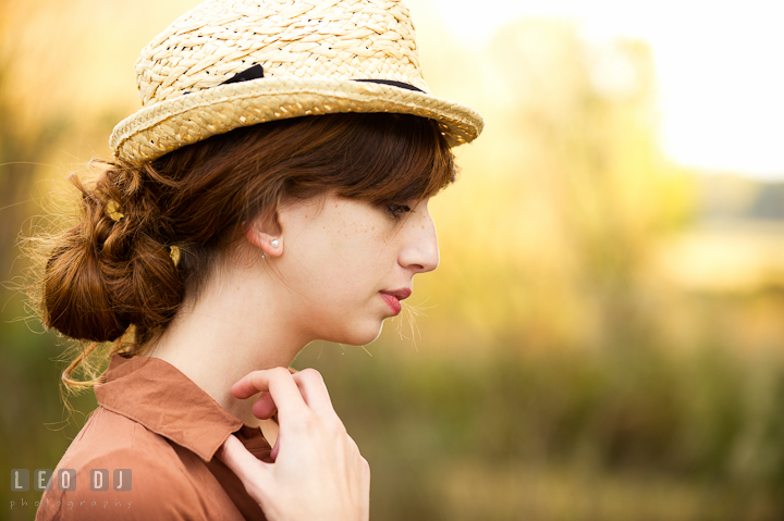 Pretty girl with hair up-do, wearing hat, looking down. Easton, Centreville, Maryland, High School senior portrait session by photographer Leo Dj Photography. http://leodjphoto.com