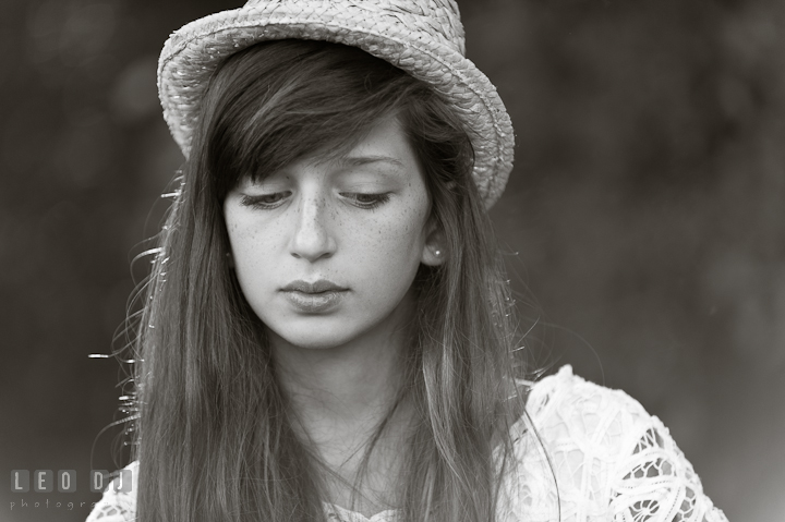 Girl with long hair and hat looking down. Eastern Shore, Maryland, High School senior portrait session by photographer Leo Dj Photography. http://leodjphoto.com