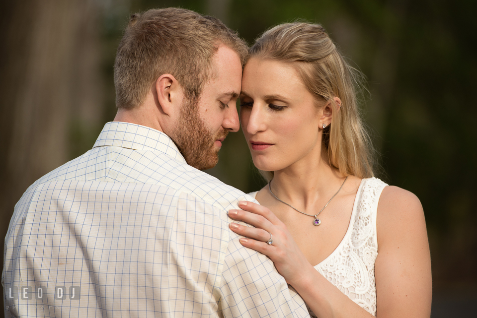 Engaged girl holding her fiancé. Quiet Waters Park Annapolis Maryland pre-wedding engagement photo session, by wedding photographers of Leo Dj Photography. http://leodjphoto.com