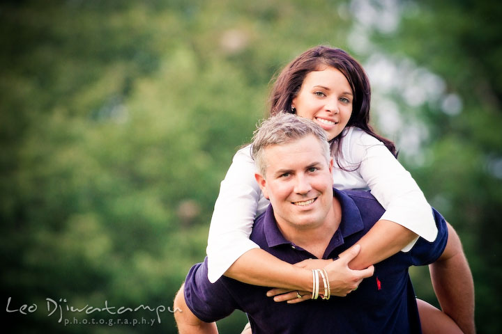 engaged guy giving piggy back ride for his fiancee. Kent Island, Eastern Shore, Maryland Engagement Pre-wedding photography session
