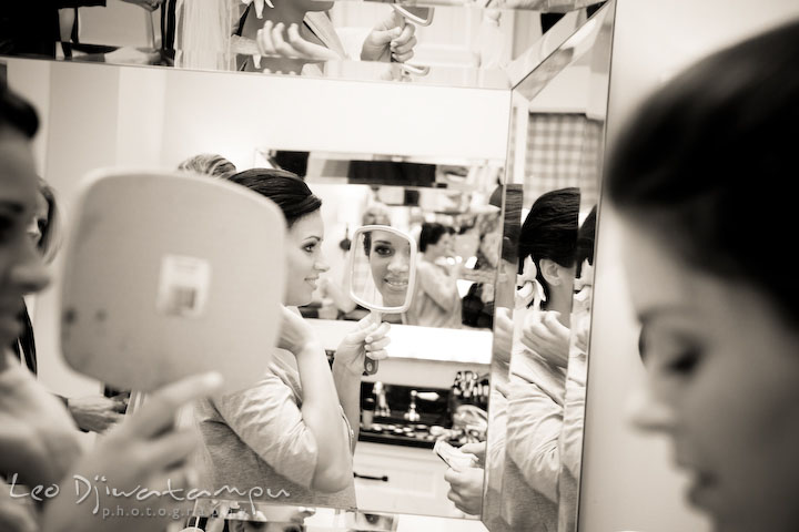 The bride checking out her hairdo on the mirror. Annapolis Wedding Photographer, Wedding at St Mary's Catholic Church Annapolis Maryland.