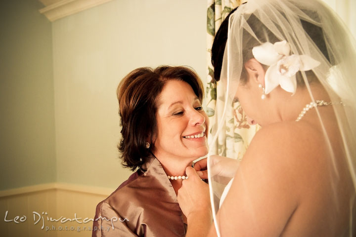 Bride helping her mother putting on some jewelery, necklace. Annapolis Wedding Photographer, Wedding at St Mary's Catholic Church Annapolis Maryland.