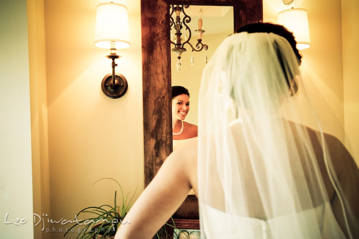 Beautiful bride looking at the mirror, smiling, ready to go. Annapolis Wedding Photographer, Wedding at St Mary's Catholic Church Annapolis Maryland.