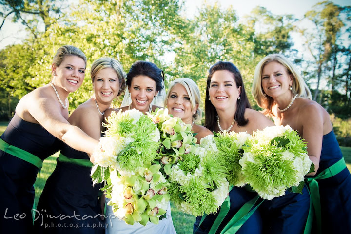 Bride, maid of honor, and bridesmaids showing their bouquet. Annapolis Kent Island Maryland Wedding Photography with live dance band at reception