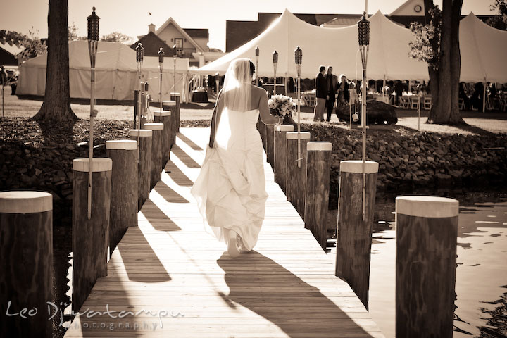 Bride holding bouquet and walking down the pier. Annapolis Kent Island Maryland Wedding Photography with live dance band at reception