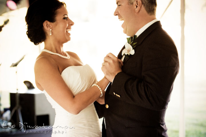 Bride and groom dancing at first dance and laughing together. Annapolis Kent Island Maryland Wedding Photography with live dance band at reception