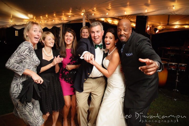 Bride, groom, guests, and wedding band singer posing and having fun. Annapolis Kent Island Maryland Wedding Photography with live dance band at reception