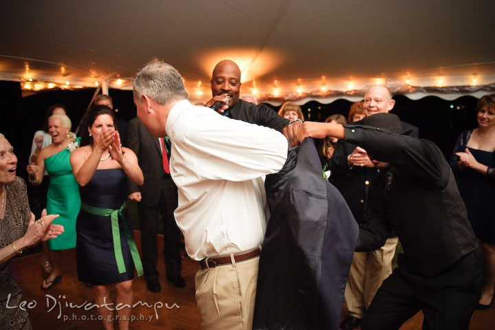 The groom taking off his jacket to get ready to dance. Annapolis Kent Island Maryland Wedding Photography with live dance band at reception