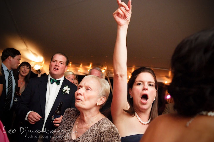 Grandmother, bridesmaid, groomsman and other guests, shouting out and singing along with the band. Annapolis Kent Island Maryland Wedding Photography with live dance band at reception