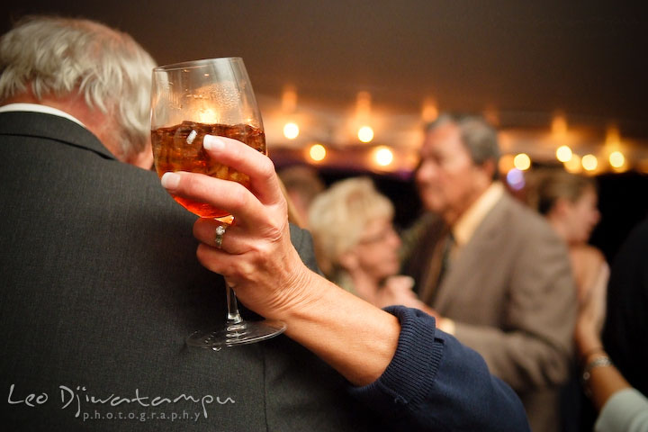 Guests dancing together, while holding a wine glass. Annapolis Kent Island Maryland Wedding Photography with live dance band at reception