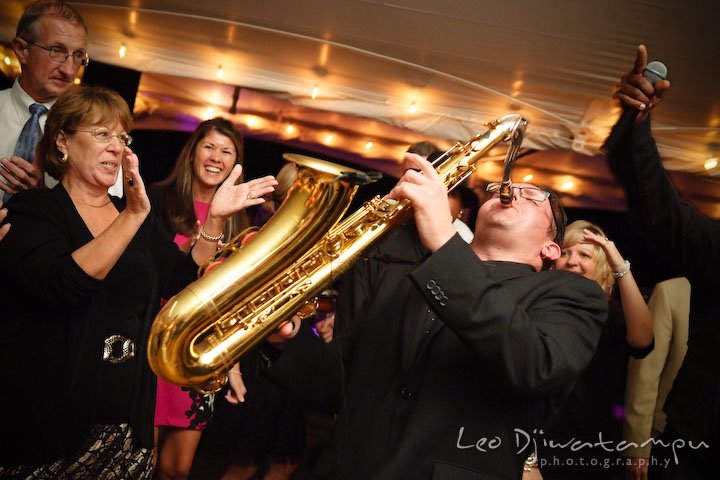 Band's saxophonist showing off his skills. Annapolis Kent Island Maryland Wedding Photography with live dance band at reception