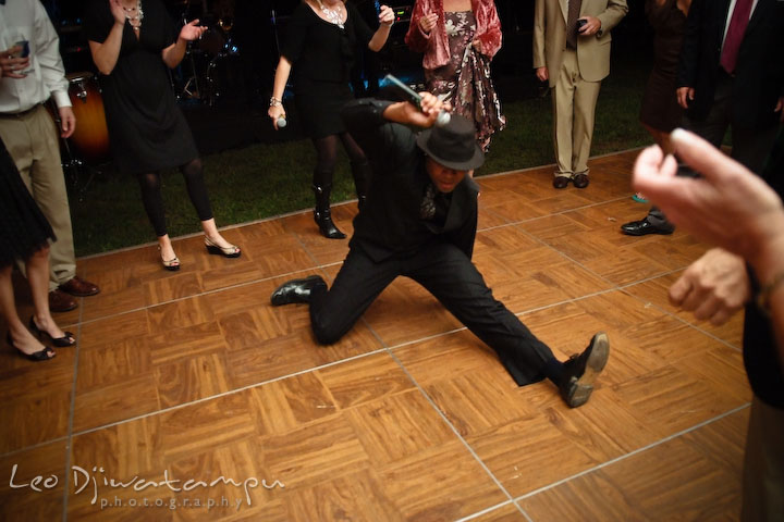 Onyx band's male singer doing a split on the dance floor. Annapolis Kent Island Maryland Wedding Photography with live dance band at reception