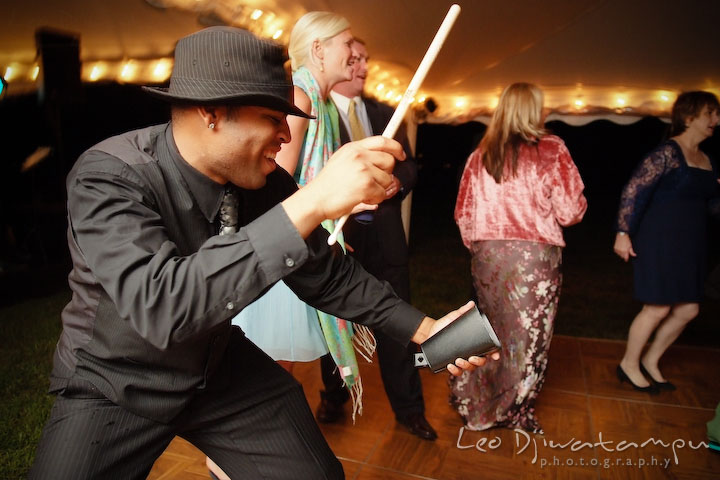 The band's vocalist playing cowbell. Annapolis Kent Island Maryland Wedding Photography with live dance band at reception