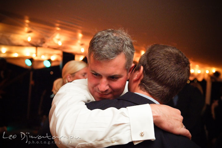 Groom hugging one of the guests. Annapolis Kent Island Maryland Wedding Photography with live dance band at reception