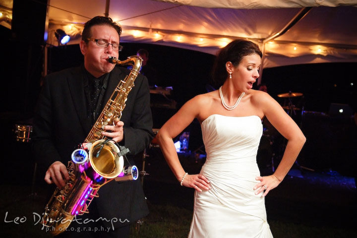 Saxophonist displaying lights and bride dancing. Annapolis Kent Island Maryland Wedding Photography with live dance band at reception